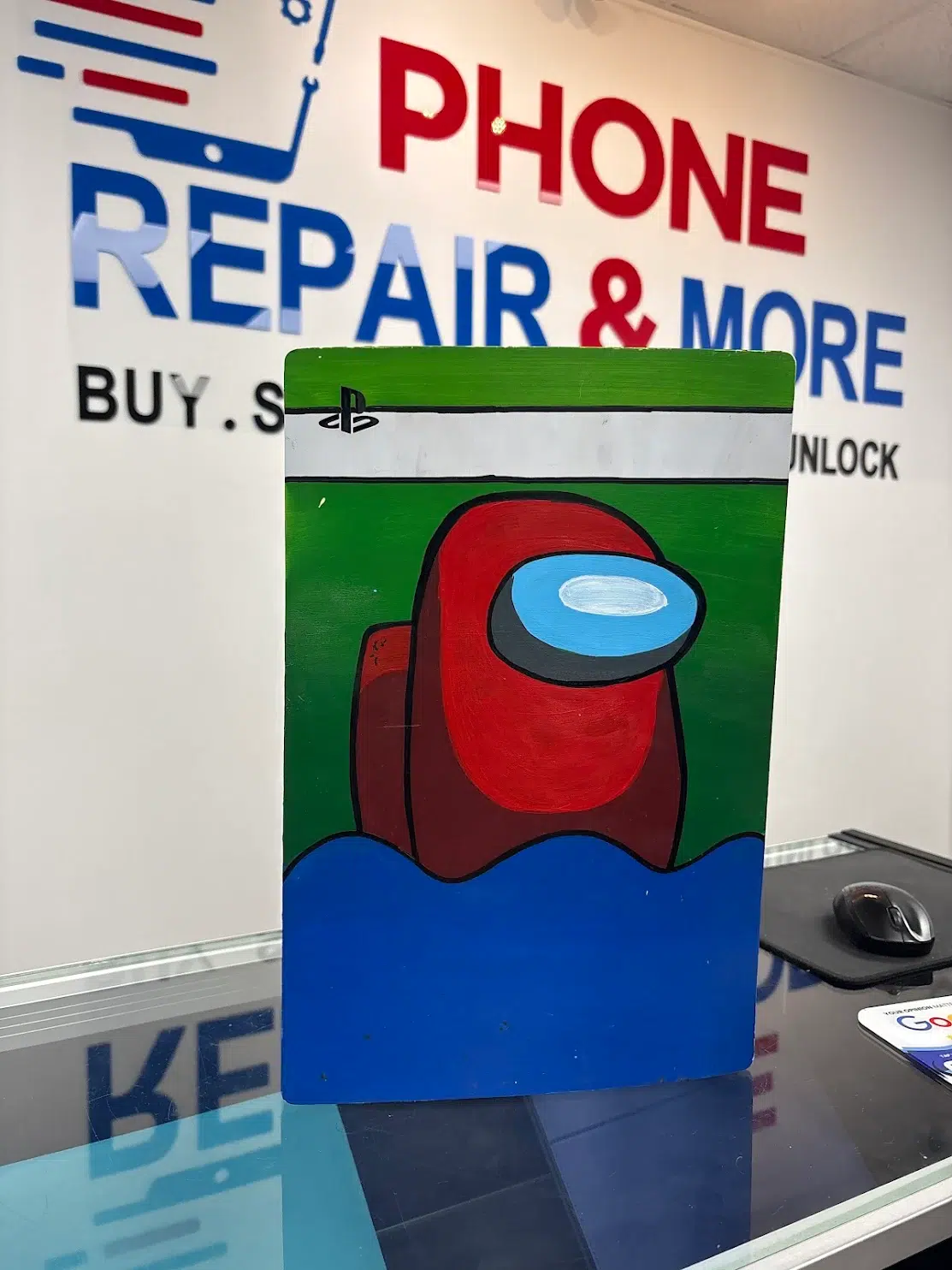 Custom hand-painted PS5 console cover on display at the Wesley Chapel store