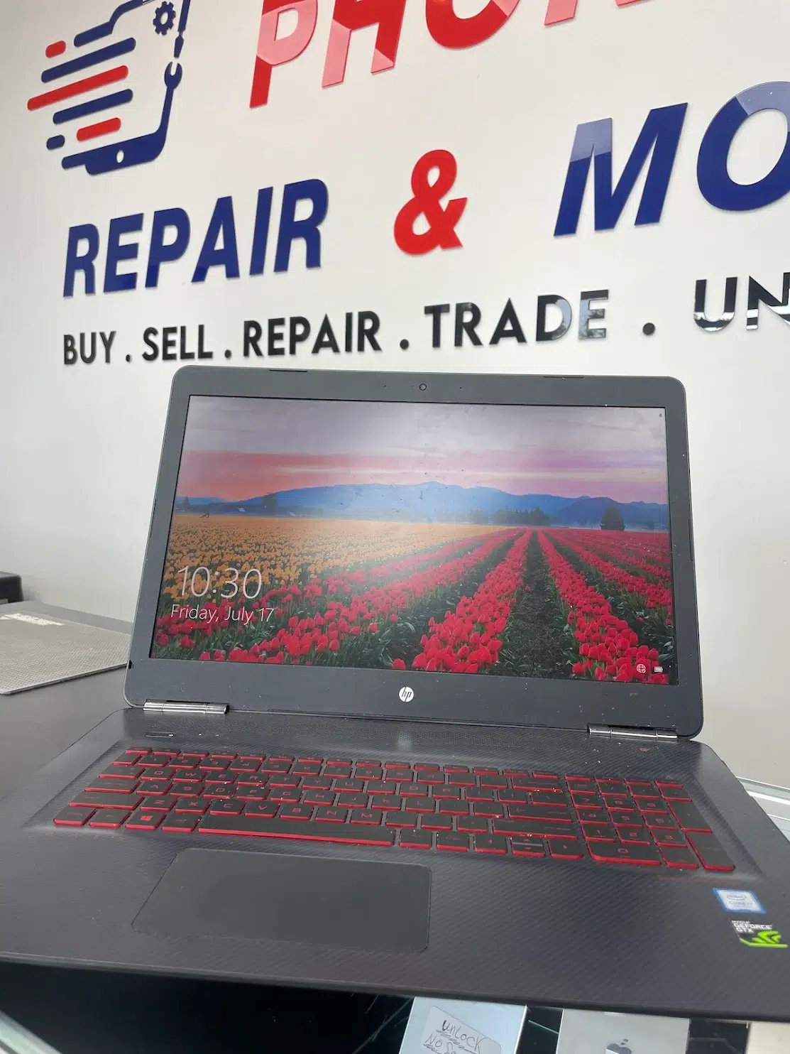 Laptop display being inspected on a professional repair bench