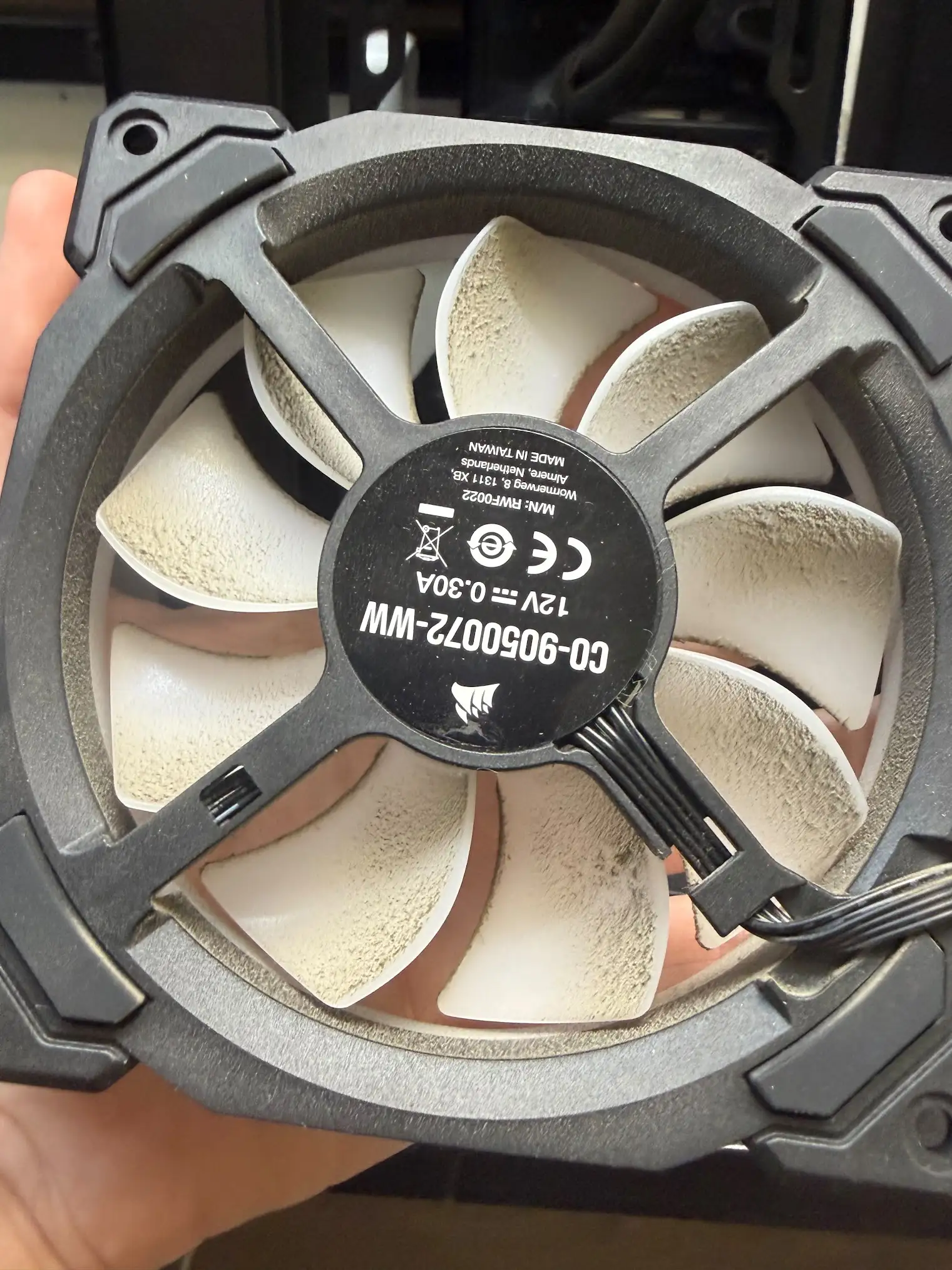 Dust buildup on a computer cooling fan during repair