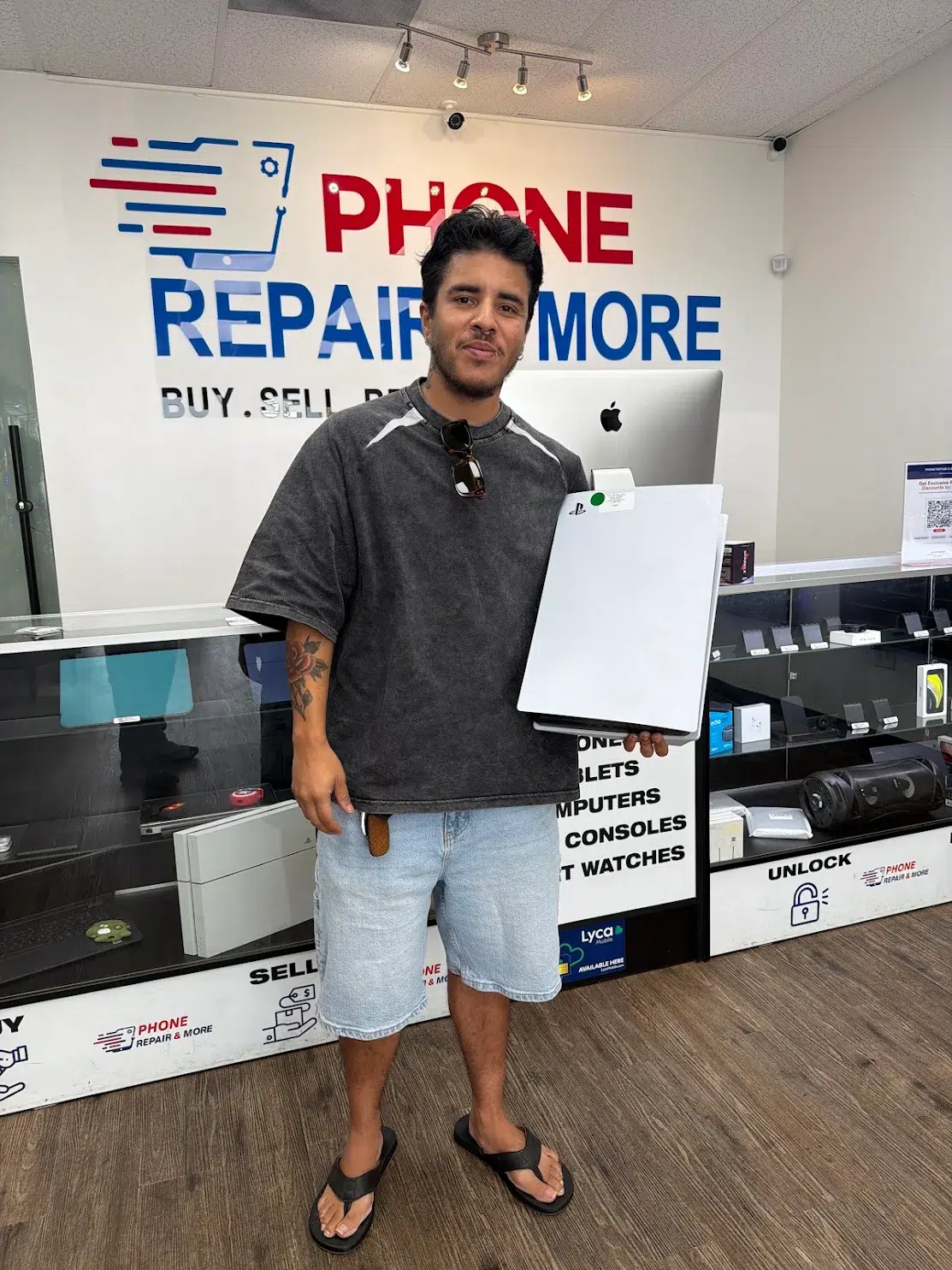 Customer with a PlayStation 5 at Phone Repair & More in St. Petersburg Florida