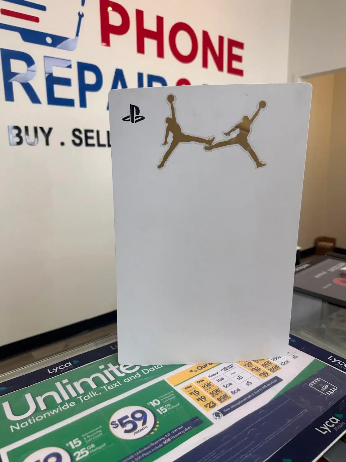 Custom Jordan edition PS5 console at the Phone Repair & More Carrollwood store
