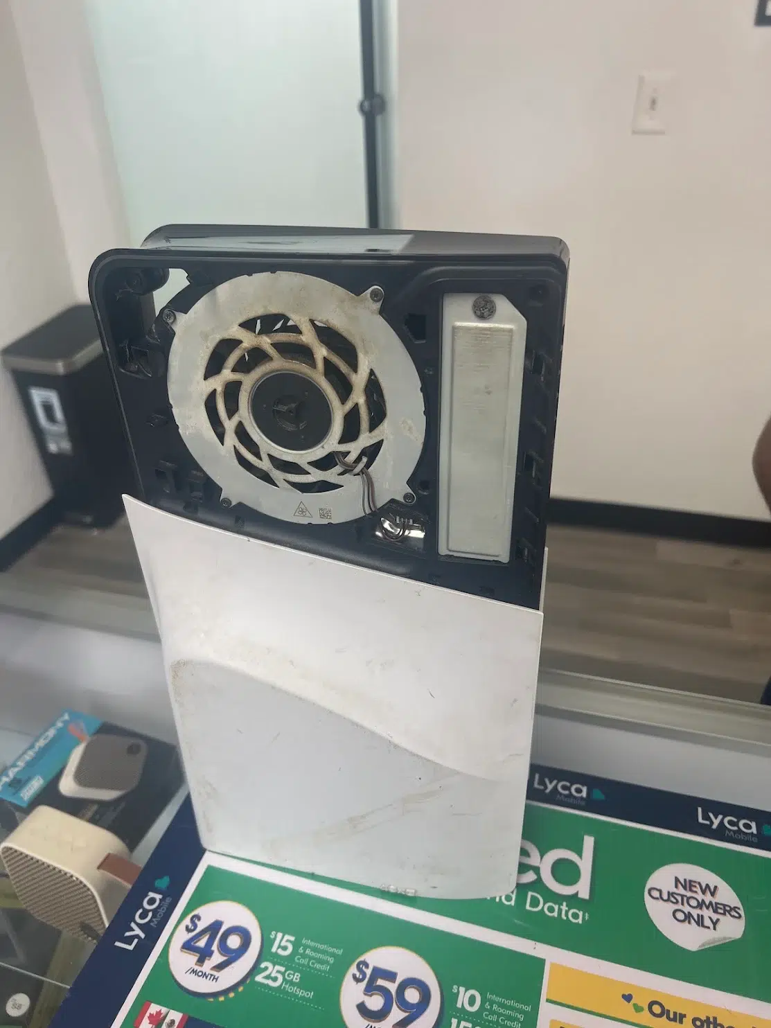 PS5 with the outer shell removed exposing the cooling fan at Phone Repair & More Wesley Chapel